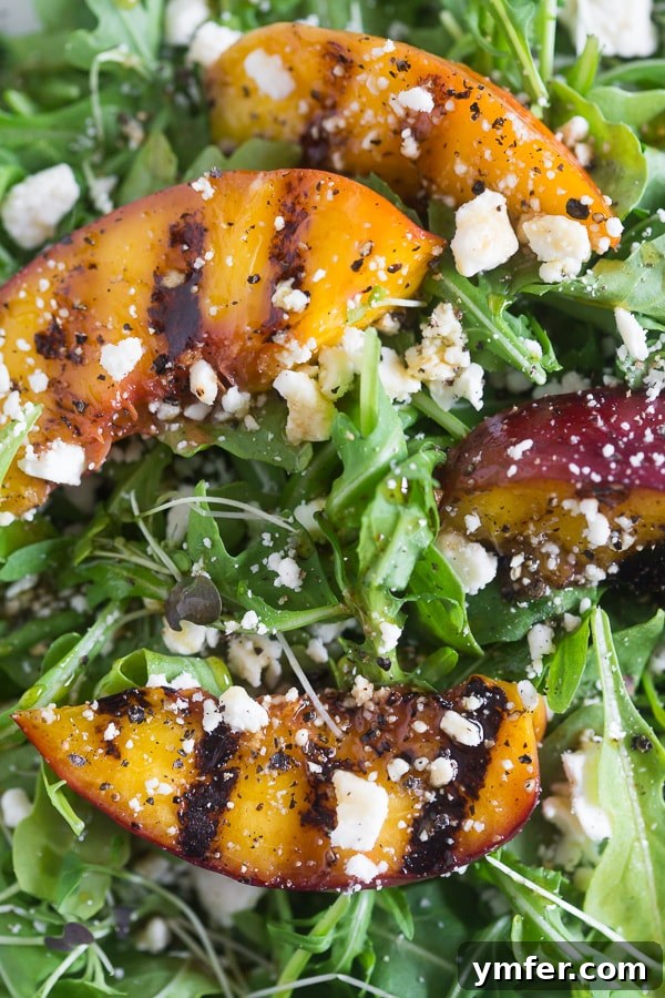 Sweet & Smoky Grilled Nectarine and Feta Salad 3 A grilled nectarine on a salad.