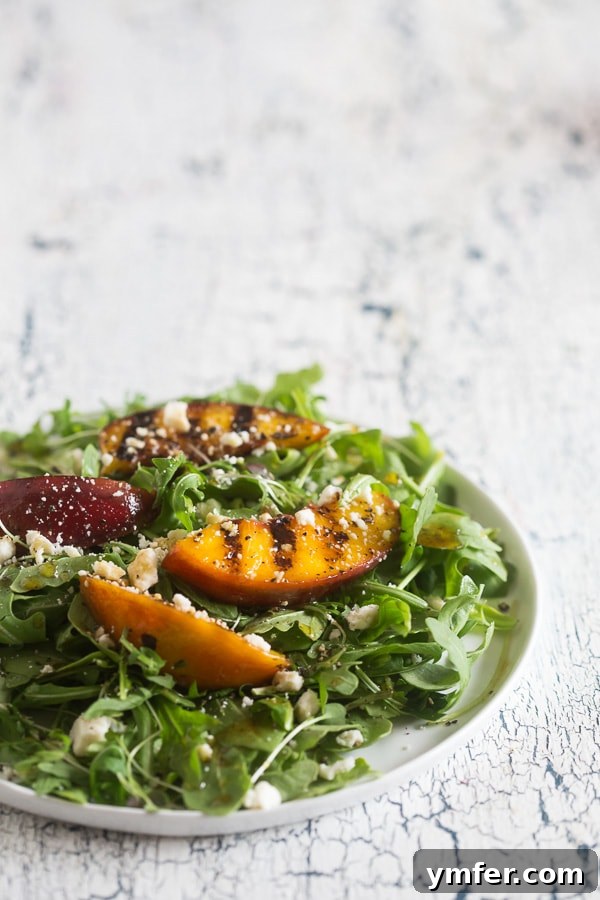 Sweet & Smoky Grilled Nectarine and Feta Salad 5 Grilled Nectarine Salad on a white plate.
