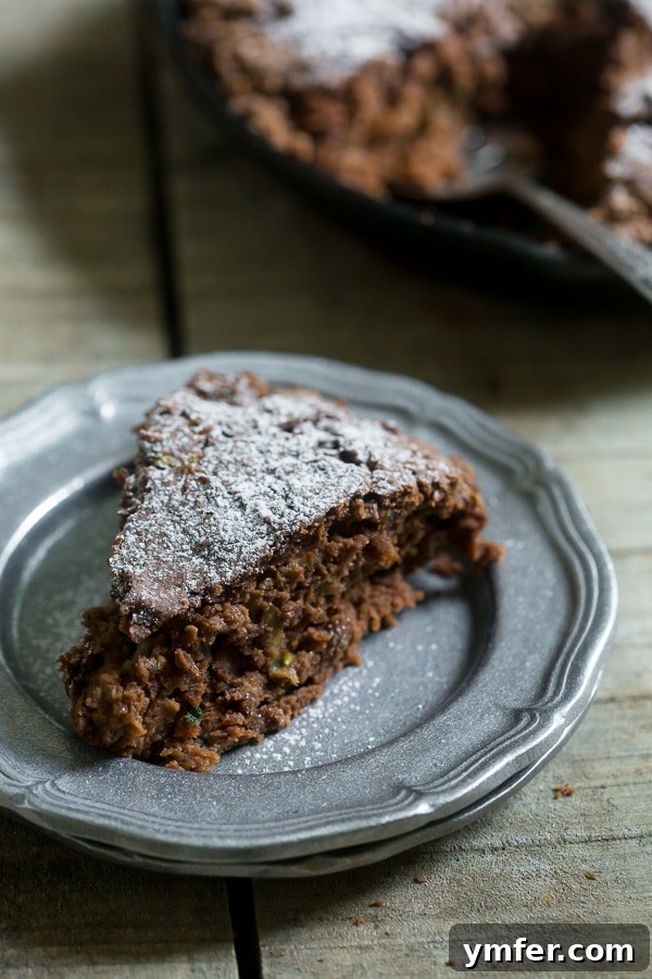 Decadent Chocolate Zucchini Date Cake 2 Delicious and moist chocolate zucchini date cake, lightly dusted with powdered sugar, ready to be served