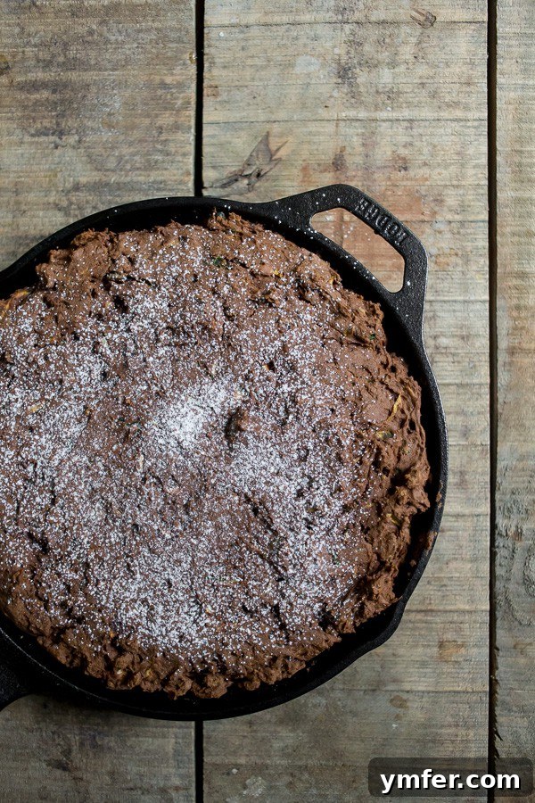 Decadent Chocolate Zucchini Date Cake 3 A perfectly baked slice of gluten-free chocolate zucchini date cake, showcasing its moist texture and date pieces