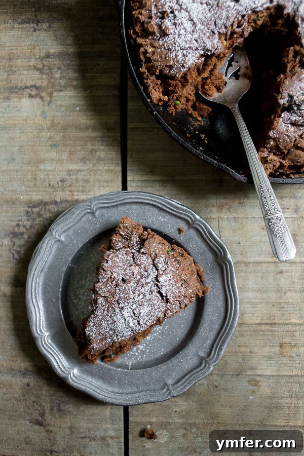 Decadent Chocolate Zucchini Date Cake 4 The finished chocolate zucchini date cake, freshly baked in a cast iron skillet, ready to be enjoyed
