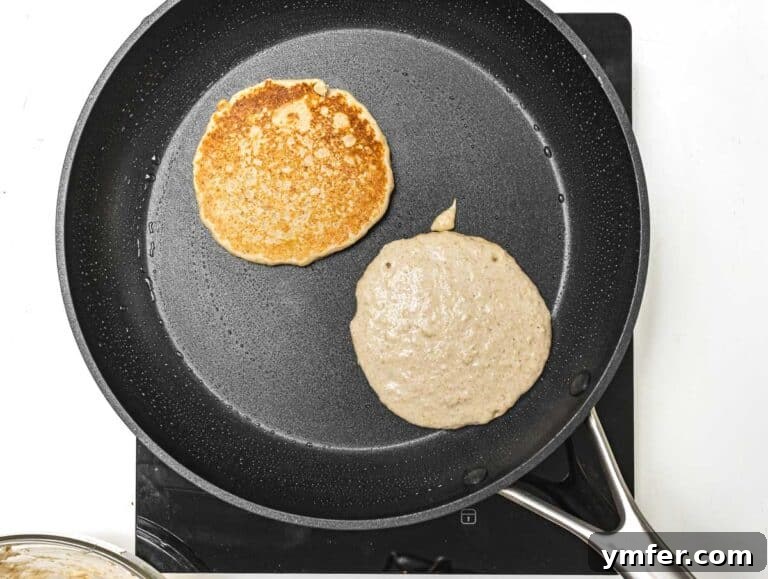Hearty Oat Flapjacks 10 Oatmeal pancakes cooking on a pan.