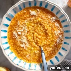 A comforting bowl of Pastina soup with grated Parmesan.