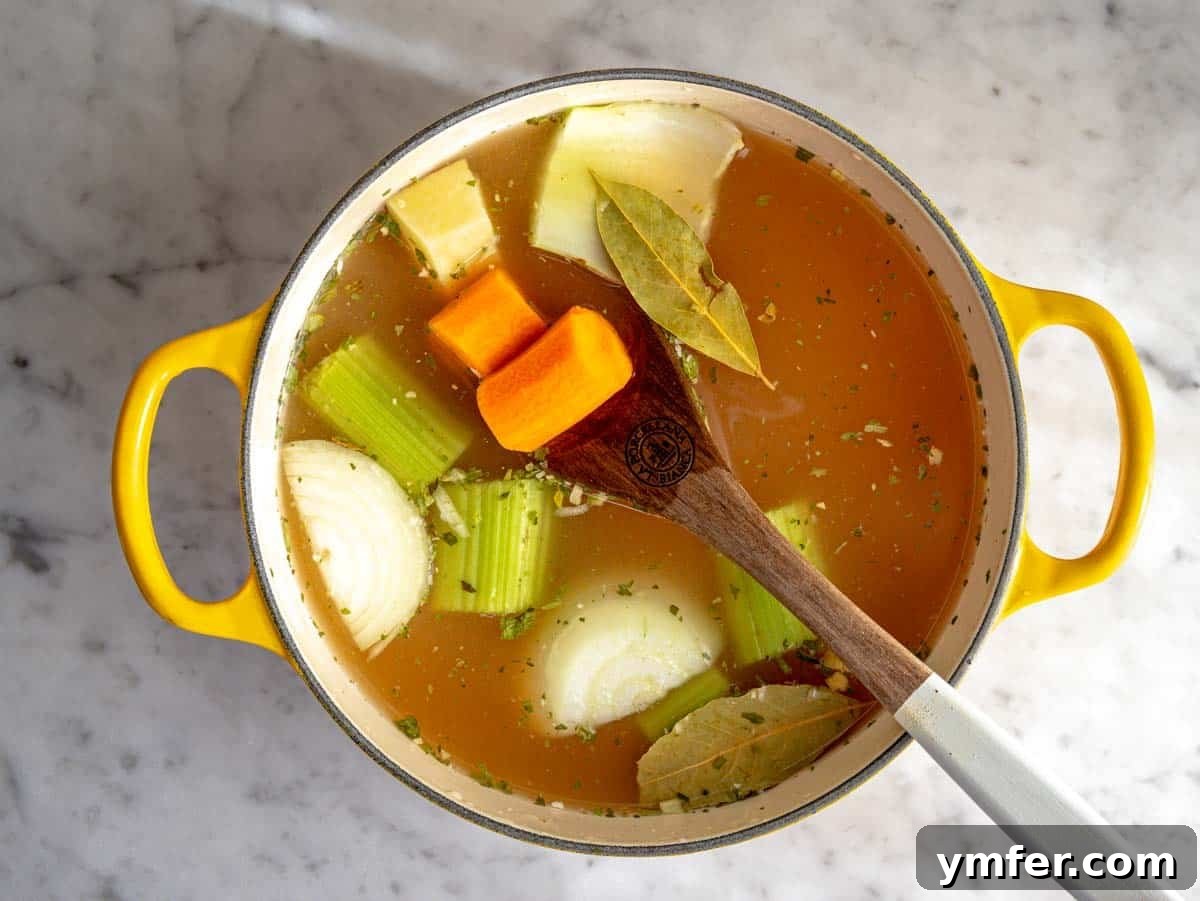 Soothing Small Pasta 8 Vegetables like celery, carrot, onion, and a small potato simmering in a rich vegetable broth.