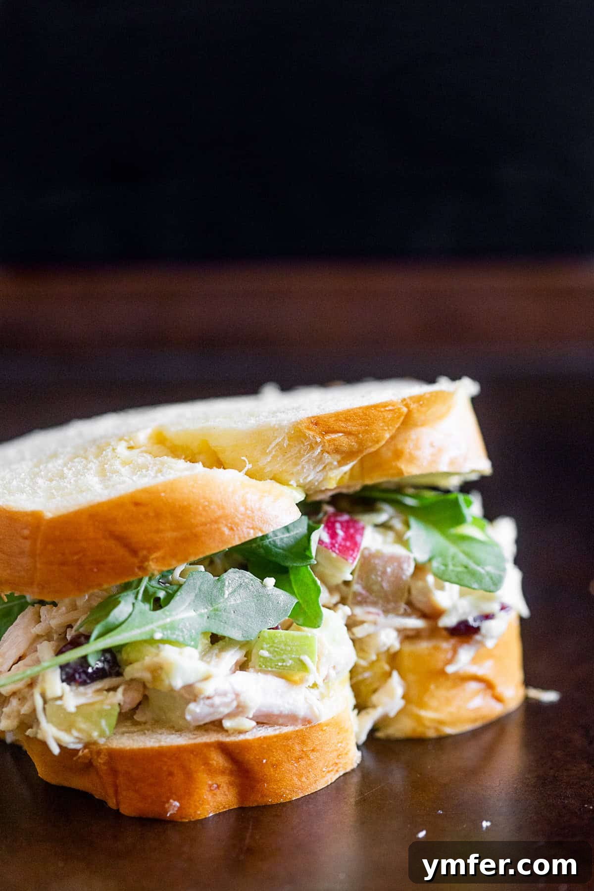Mediterranean Hummus Chicken Salad 4 Hummus Chicken Salad served on artisanal bread with fresh arugula leaves, ready to eat.