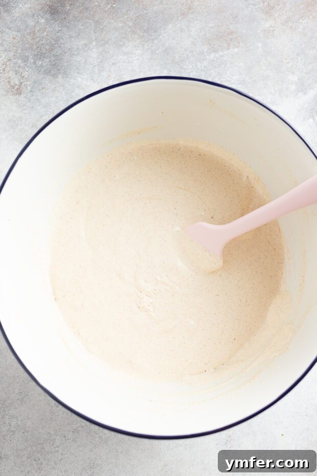 Spiced Apple Streusel Coffee Cake 5 Smooth, well-mixed cake batter in a bowl, showing its thick and fluffy consistency.