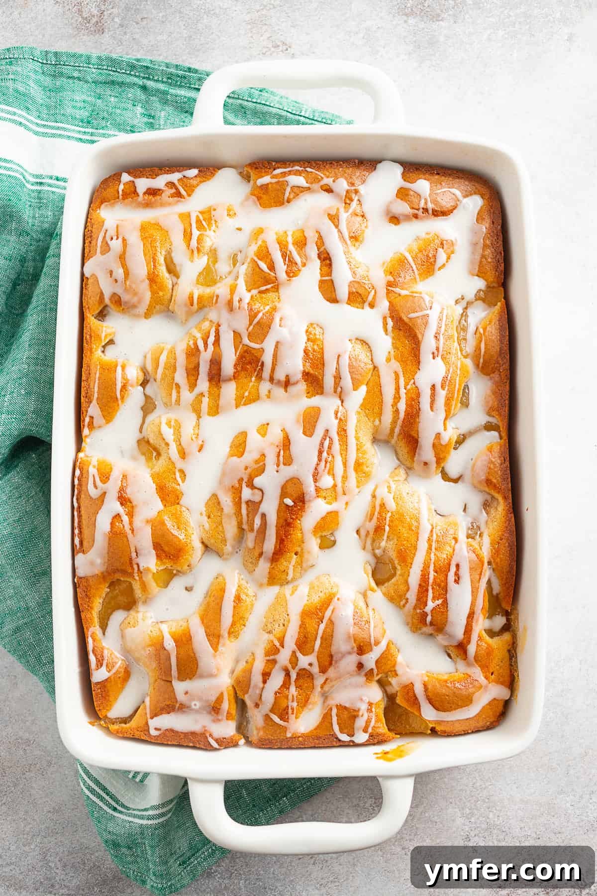 Spiced Apple Streusel Coffee Cake 9 A beautifully glazed Apple Pie Filling Coffee Cake in a baking dish, with a generous drizzle of powdered sugar glaze.