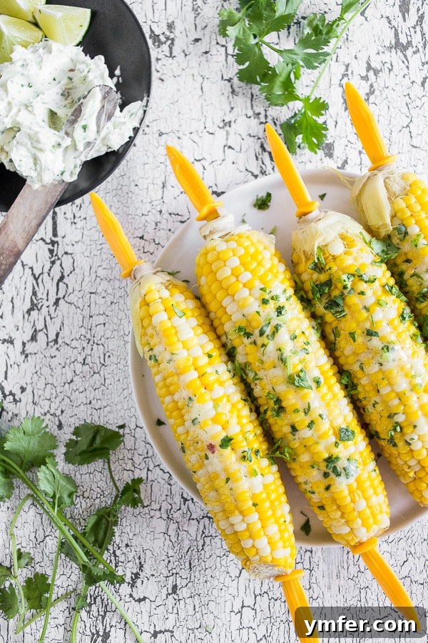 Bira Buharında Mısır Keyfi 2 Beer Steamed Corn on the Cob slathered with honey cilantro butter. A close-up shot showcasing the golden kernels and vibrant green butter.