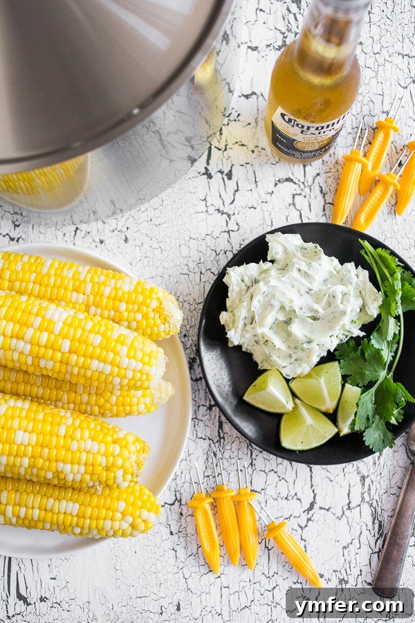 Bira Buharında Mısır Keyfi 5 Beer Steamed Corn on the Cob on a plate with honey butter on a plate. A serving of corn with a side of the flavorful butter.