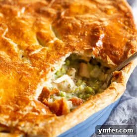 Golden Puff Pastry Turkey Pot Pie 5 Puff Pastry Turkey Pot Pie in a blue casserole dish, showcasing the vibrant filling and flaky crust.