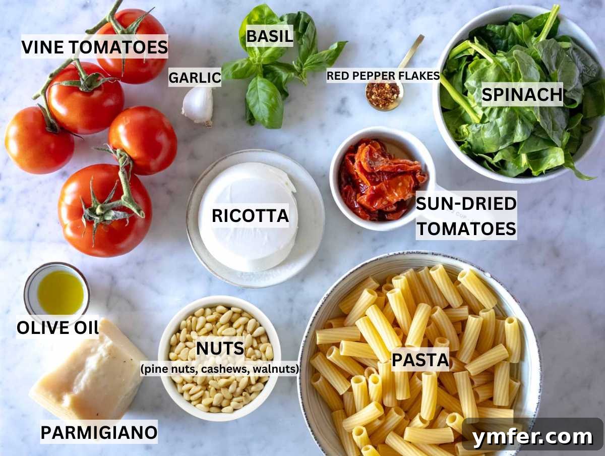 Sun-Kissed Tomato Pasta 3 Ingredients for sun-dried tomato pasta laid out on a wooden board.
