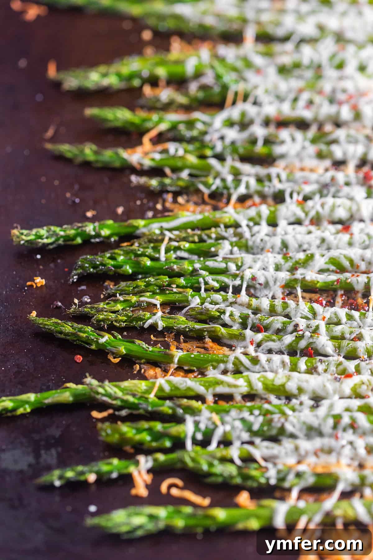 Crispy Parmesan Roasted Asparagus 4 Parmesan Roasted Asparagus on a pan, fresh from the oven, showcasing its delicious texture.