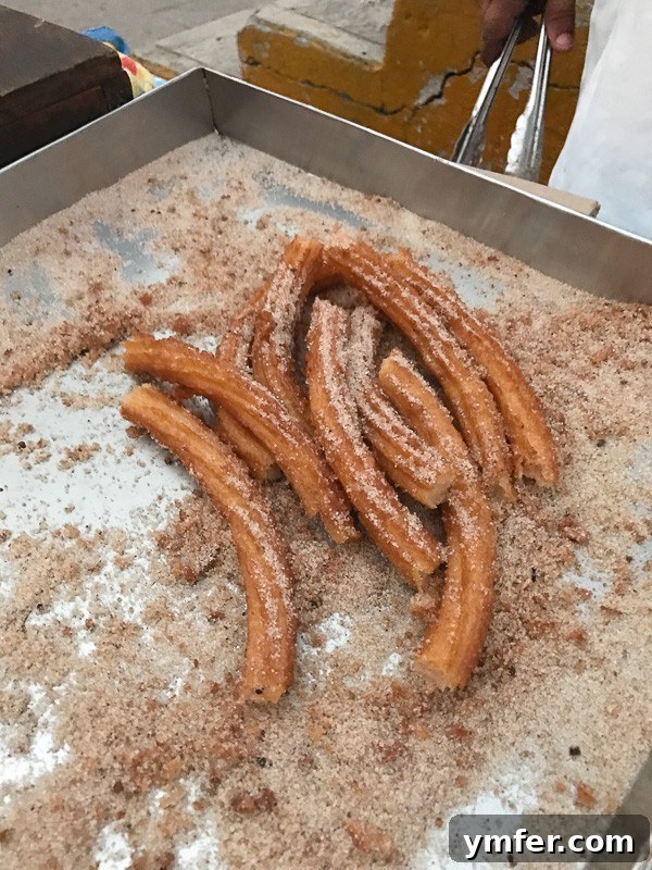 Puerto Vallarta Mexico's Pacific Gem 9 Traveler enjoying a churro with a happy expression