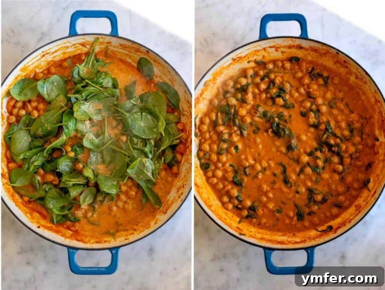 Soulmate Chickpeas 10 Fresh spinach actively wilting into the creamy chickpea mixture in the skillet.