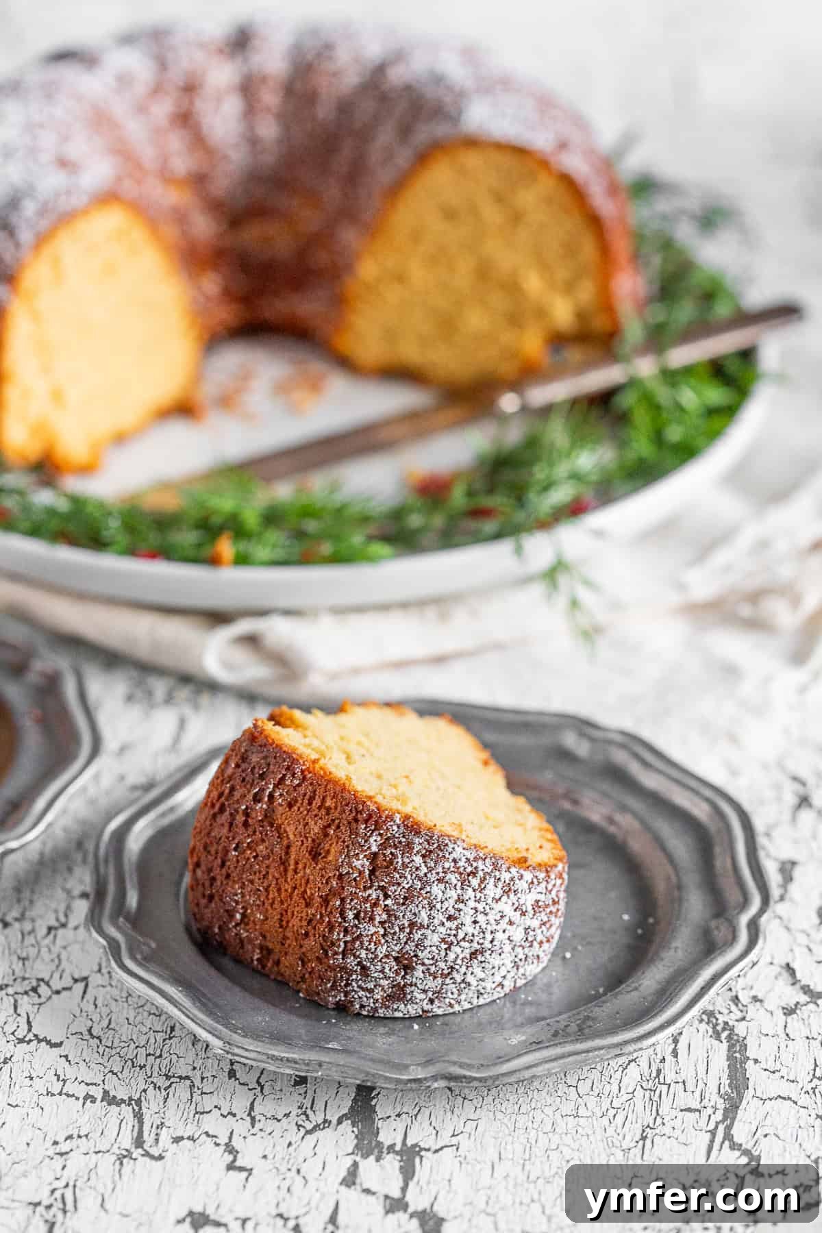 Elegant Sherry Bundt Cake 5 A close-up view of a perfectly moist slice of cream sherry bundt cake, revealing its delicate, golden crumb and inviting texture.