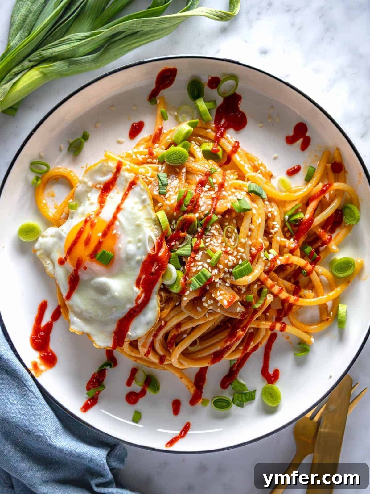Umami Gold 2 Miso Pasta with a fried egg and fresh scallions, ready to be enjoyed.