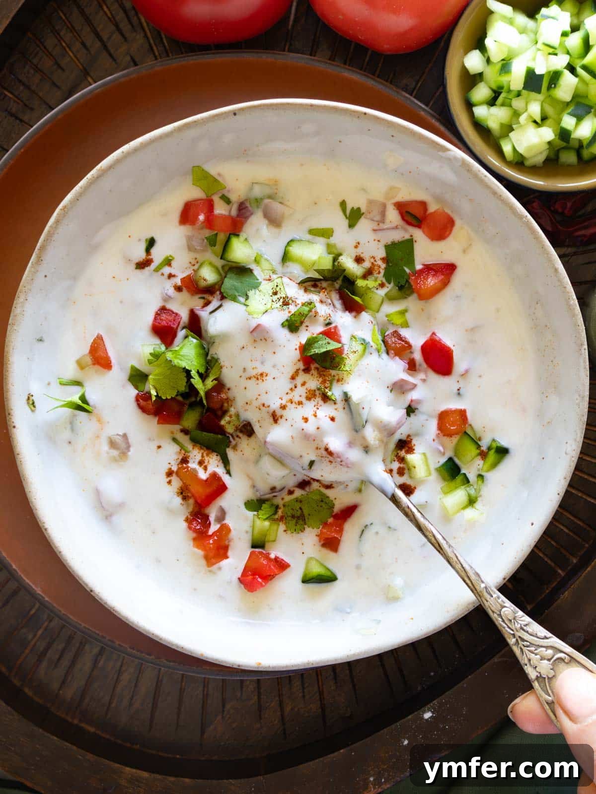 Refreshing Raita 2 Refreshing Raita yogurt sauce garnished with fresh herbs.