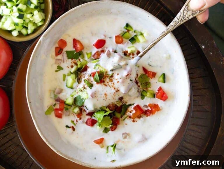 Refreshing Raita 8 Raita with yogurt, cucumber, and tomatoes in a bowl