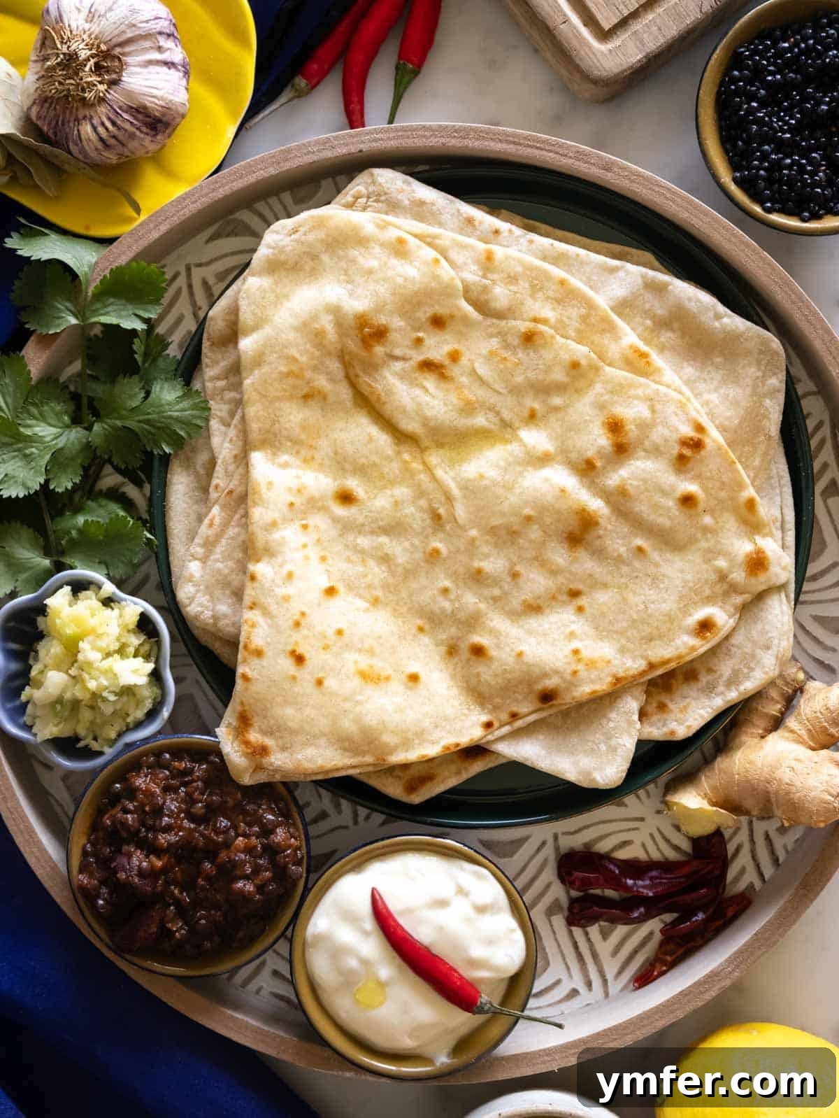 Flaky Stuffed Paratha Perfection 2 Freshly cooked parathas on a wooden tray, showing their golden-brown and flaky texture.