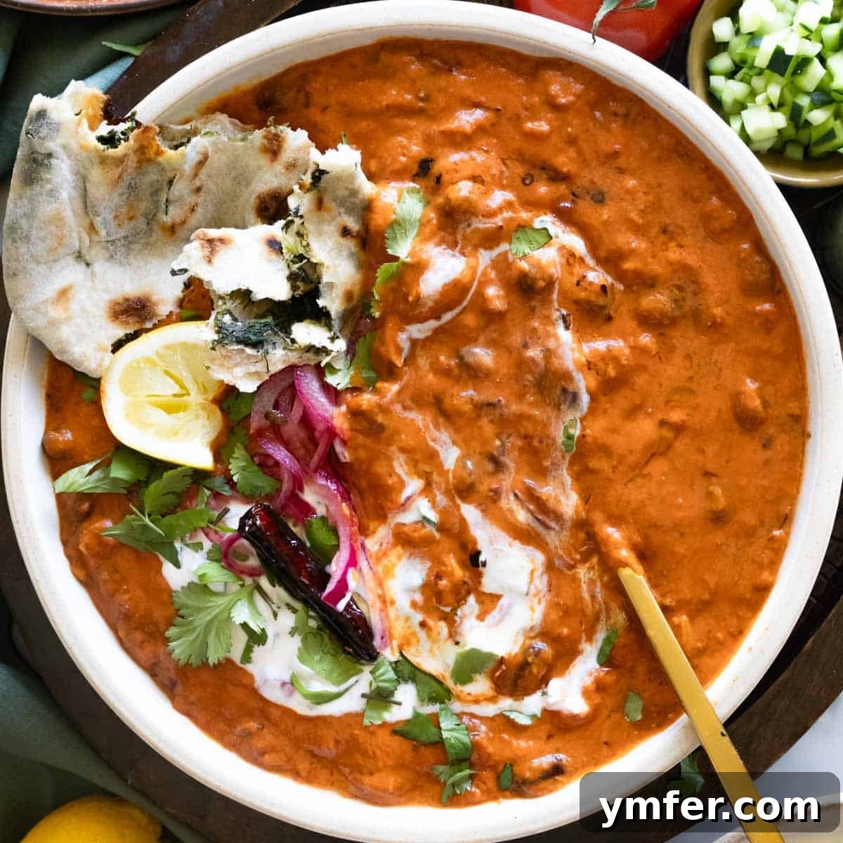 High Satisfaction Low-Calorie Meals 5 Rajma masala artfully topped with cooling raita and a side of paratha.