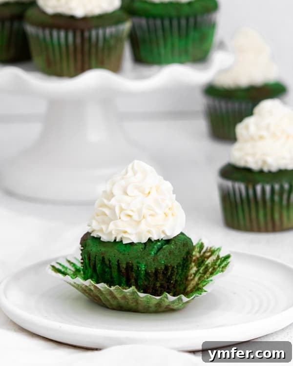 Emerald Velvet Cupcakes 4 A single green velvet cupcake, unwrapped, showing its moist and vibrant interior.