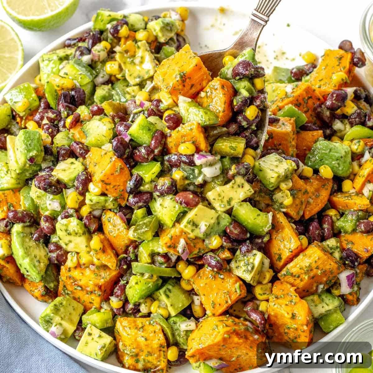 25 High Fiber Power Foods 15 black bean salad with avocado, corn and sweet potato on a white plate