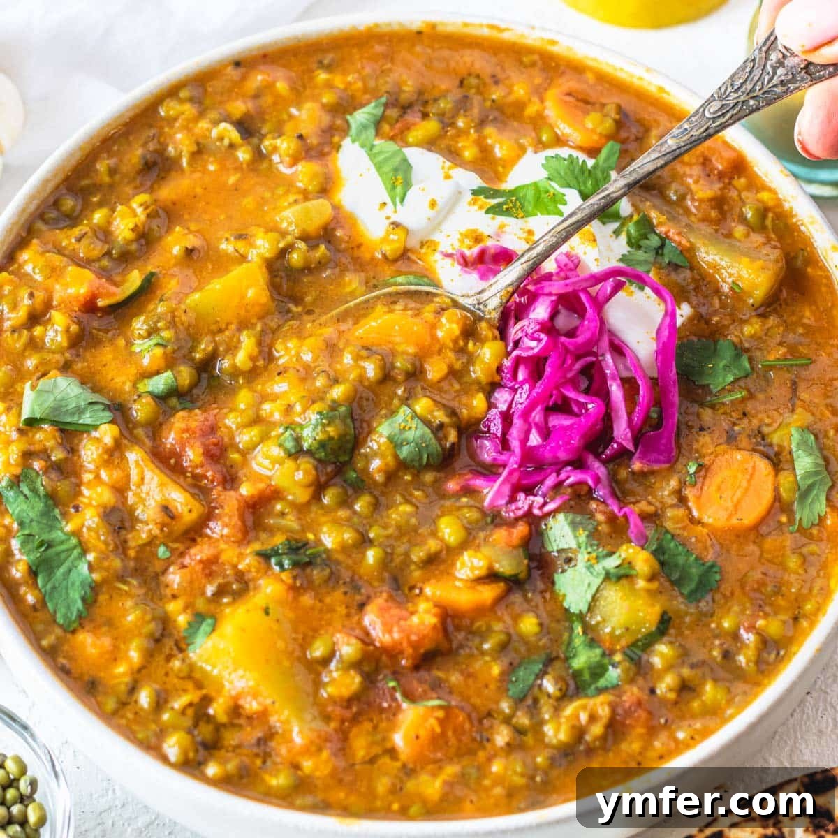 25 High Fiber Power Foods 19 Mung bean soup with pickled cabbage and hand holding a silver spoon