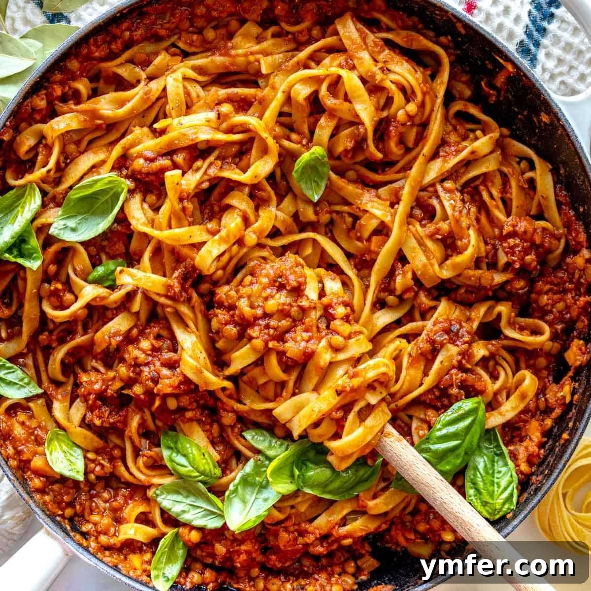25 High Fiber Power Foods 21 Lentil Bolognese in a skillet with fresh basil