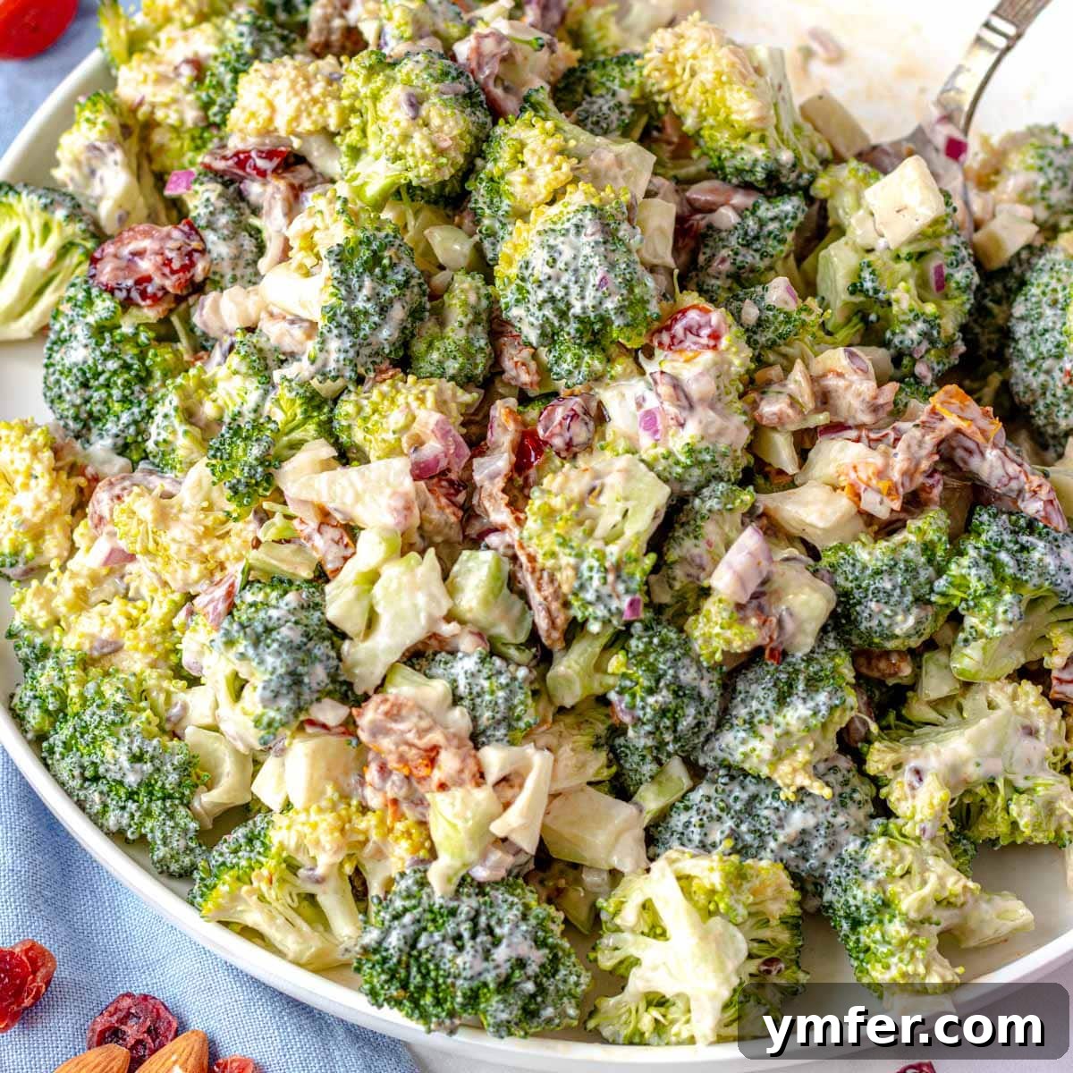 25 High Fiber Power Foods 9 Broccoli salad on a big white plate with a spoon