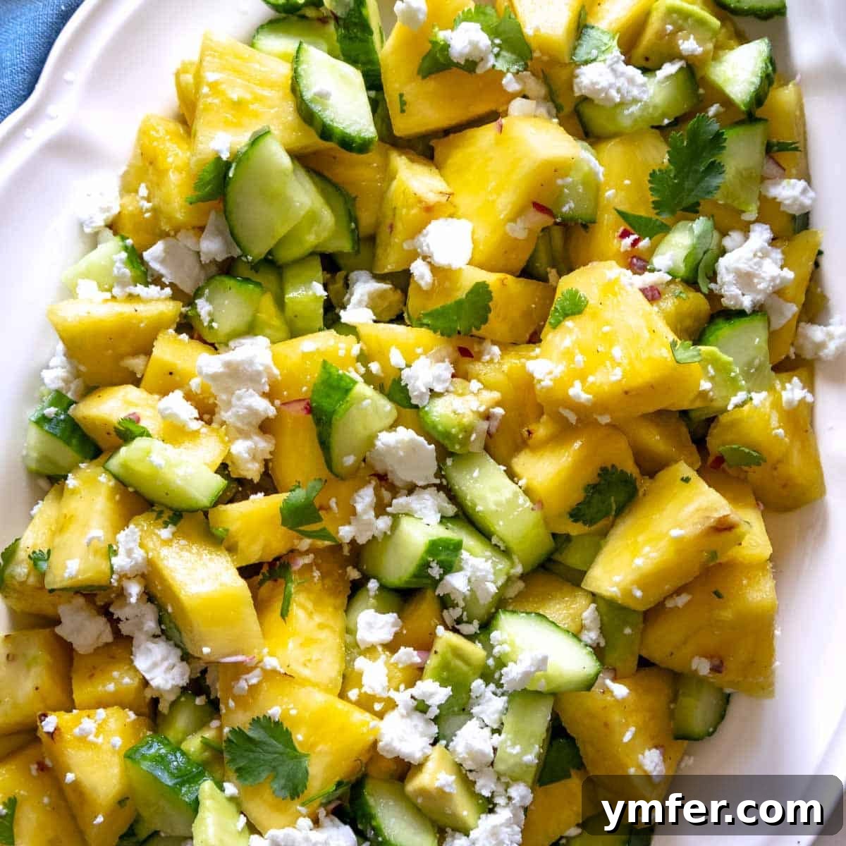 A bright and refreshing pineapple cucumber salad, featuring juicy pineapple chunks and crisp cucumber slices.
