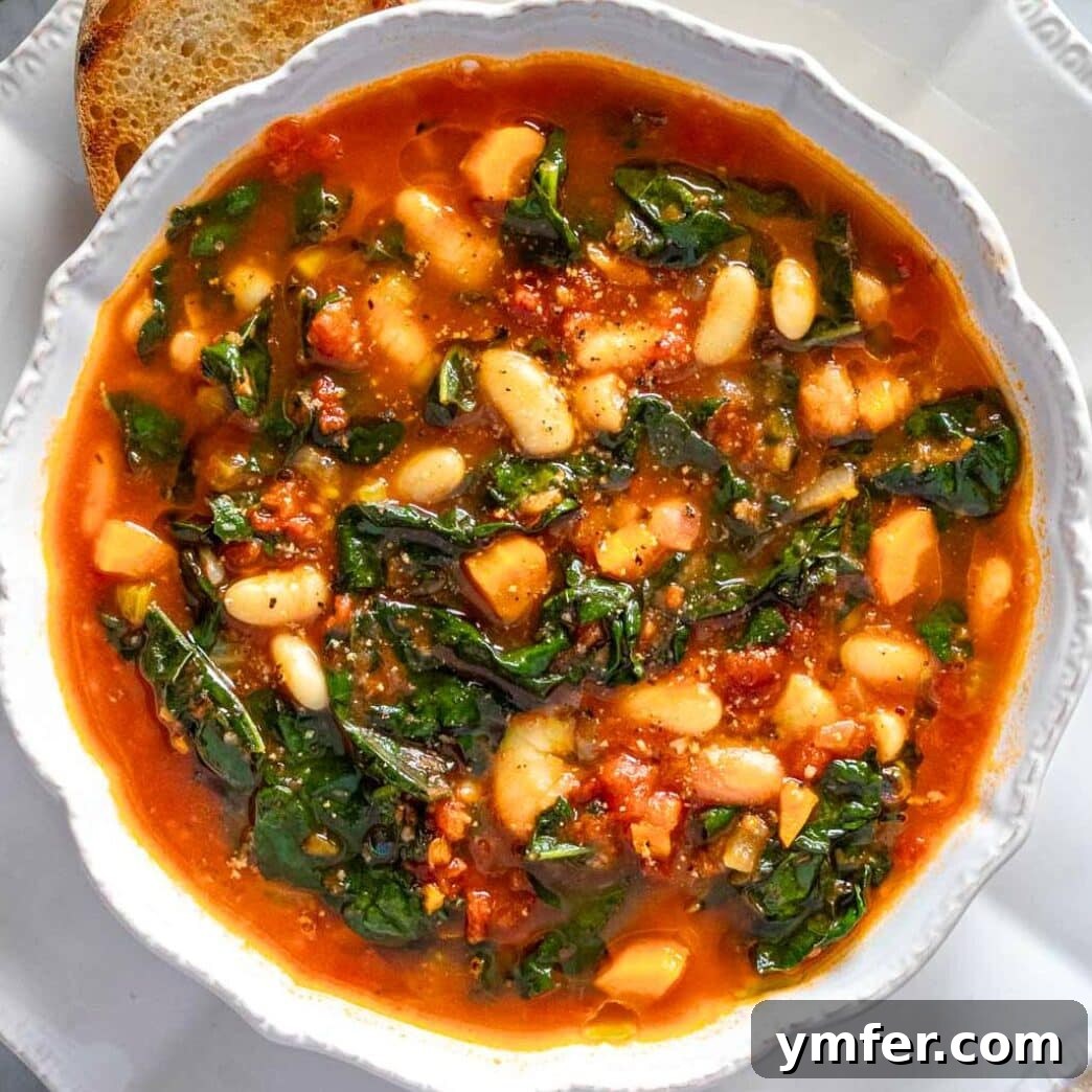 A comforting bowl of green kale soup, steaming and ready to provide warmth and nutrition.