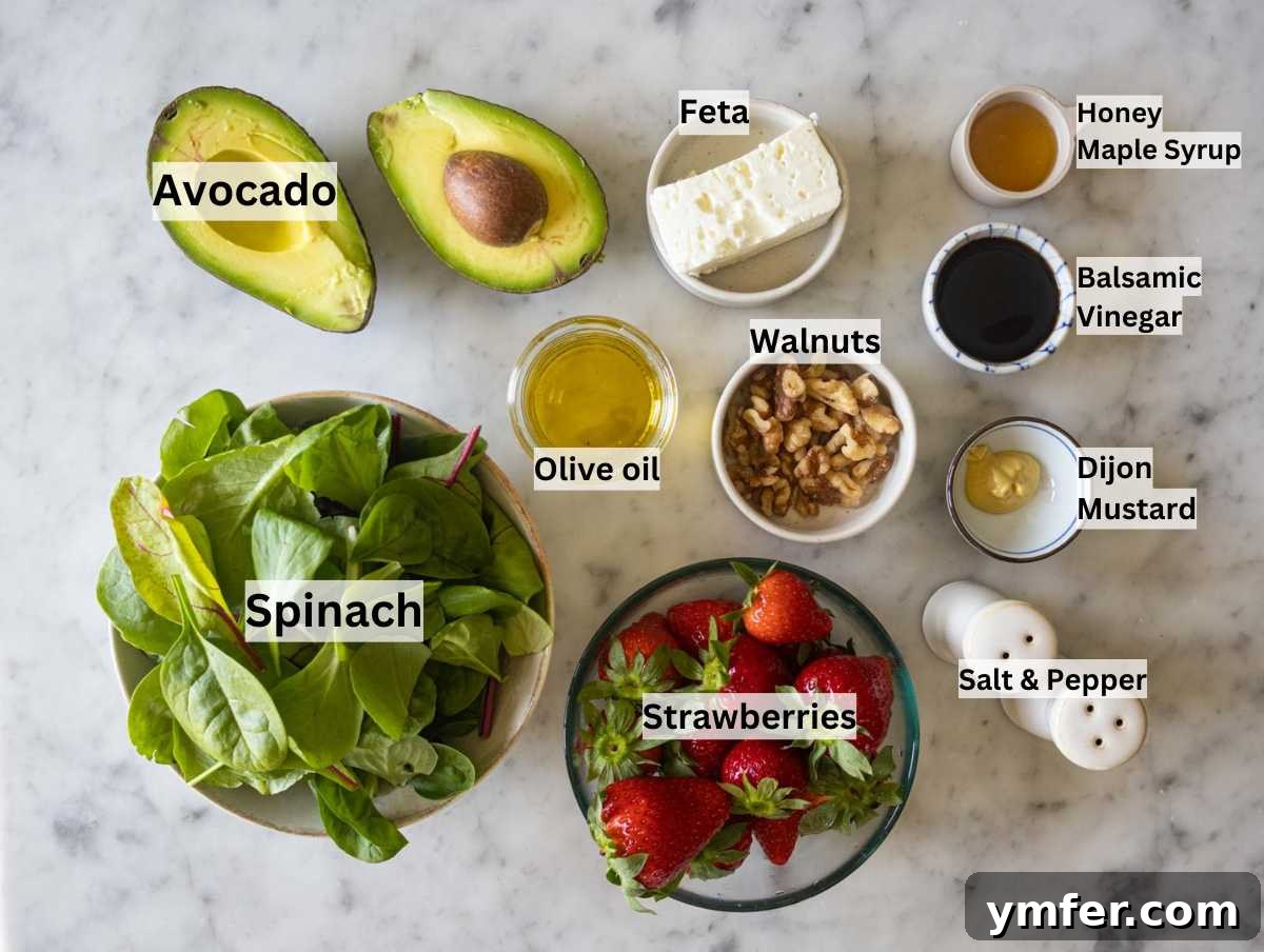 Vibrant Strawberry Spinach Salad 3 A flat lay of fresh ingredients for strawberry spinach salad, including spinach, strawberries, avocado, feta, walnuts, and dressing components.