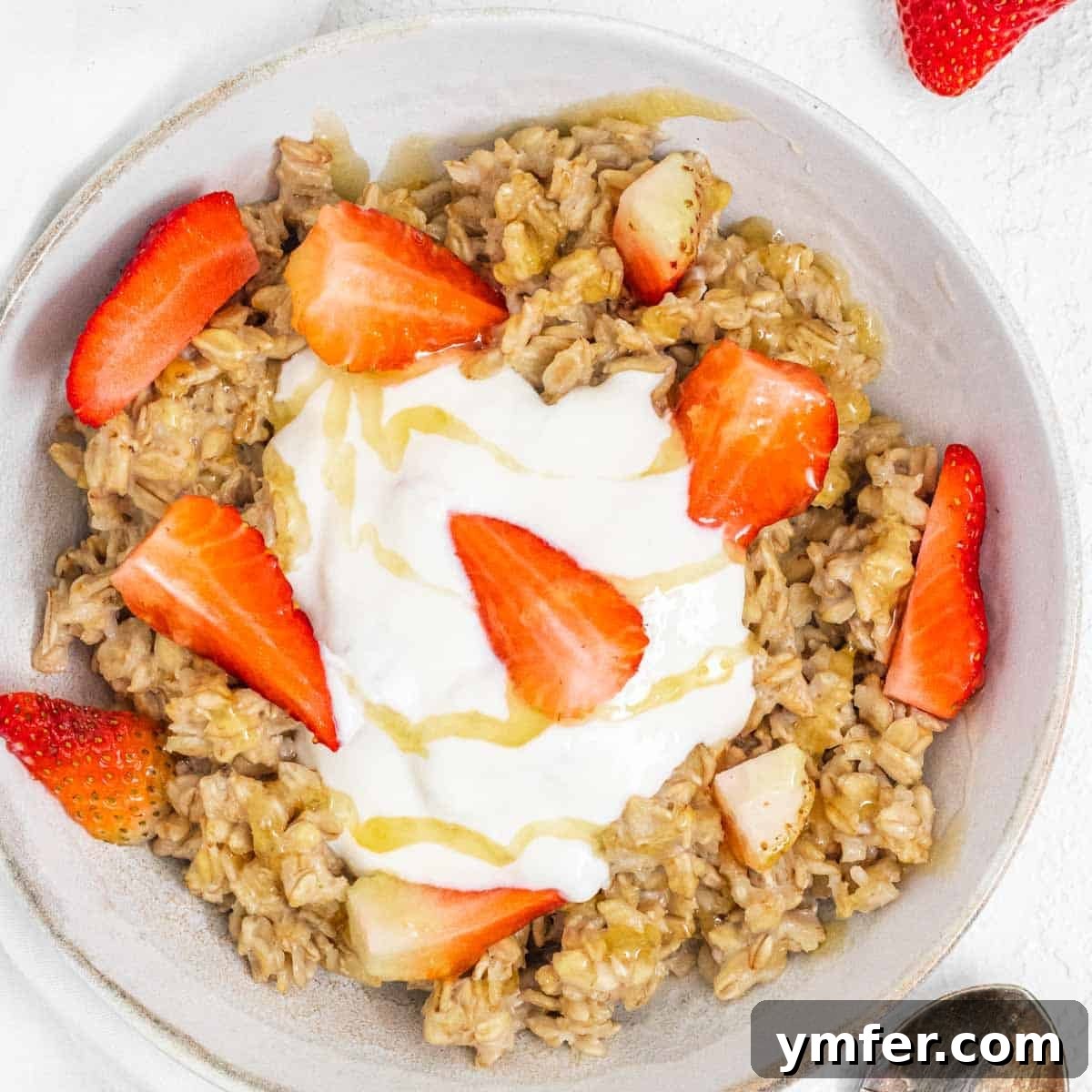 Heart-Smart Meals 15 Oatmeal with yogurt and strawberry pieces. A healthy and delicious breakfast.