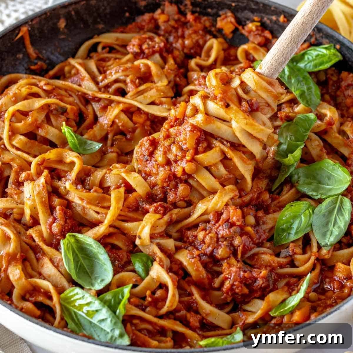 Heart-Smart Meals 25 Lentil Bolognese with fettuccine pasta and fresh basil. A hearty and flavorful vegetarian pasta dish.