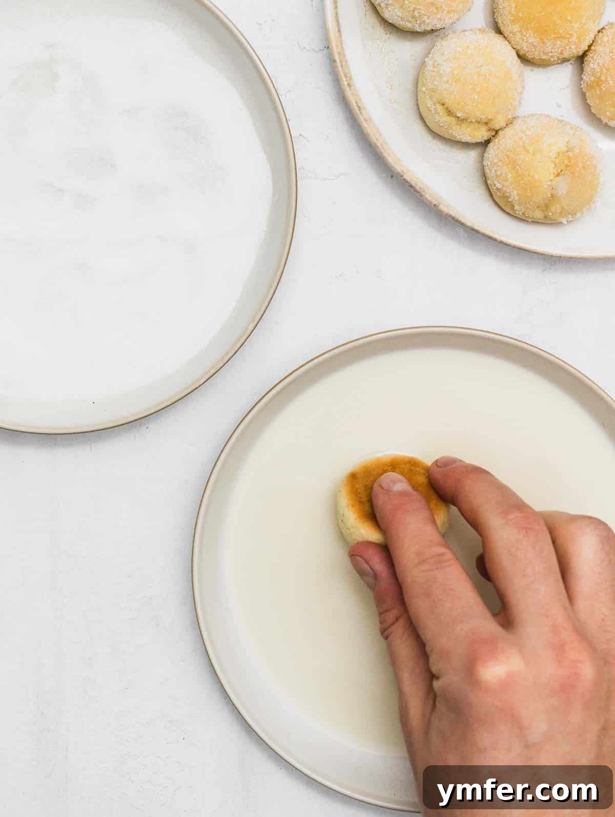 Castagnole Italian Carnival Fritters 15 Dipping the oven-baked Castagnola in plant milk to provide moisture for the sugar coating