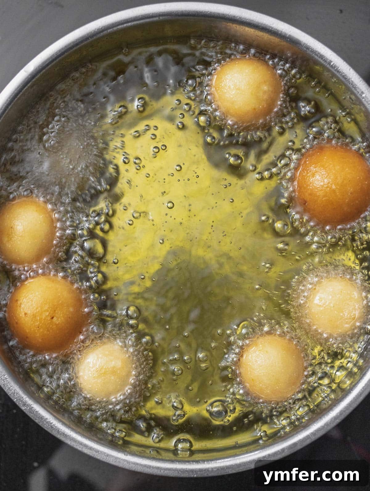 Castagnole Italian Carnival Fritters 18 Deep-frying Castagnole, showing them puffing up and turning golden brown in the hot oil