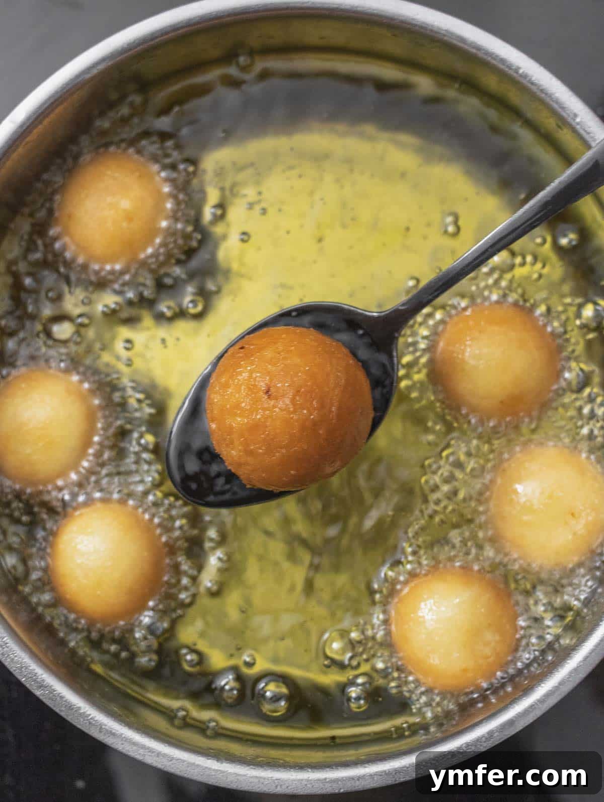 Castagnole Italian Carnival Fritters 19 Removing deep-fried Castagnole from the oil, allowing excess oil to drain onto paper towels