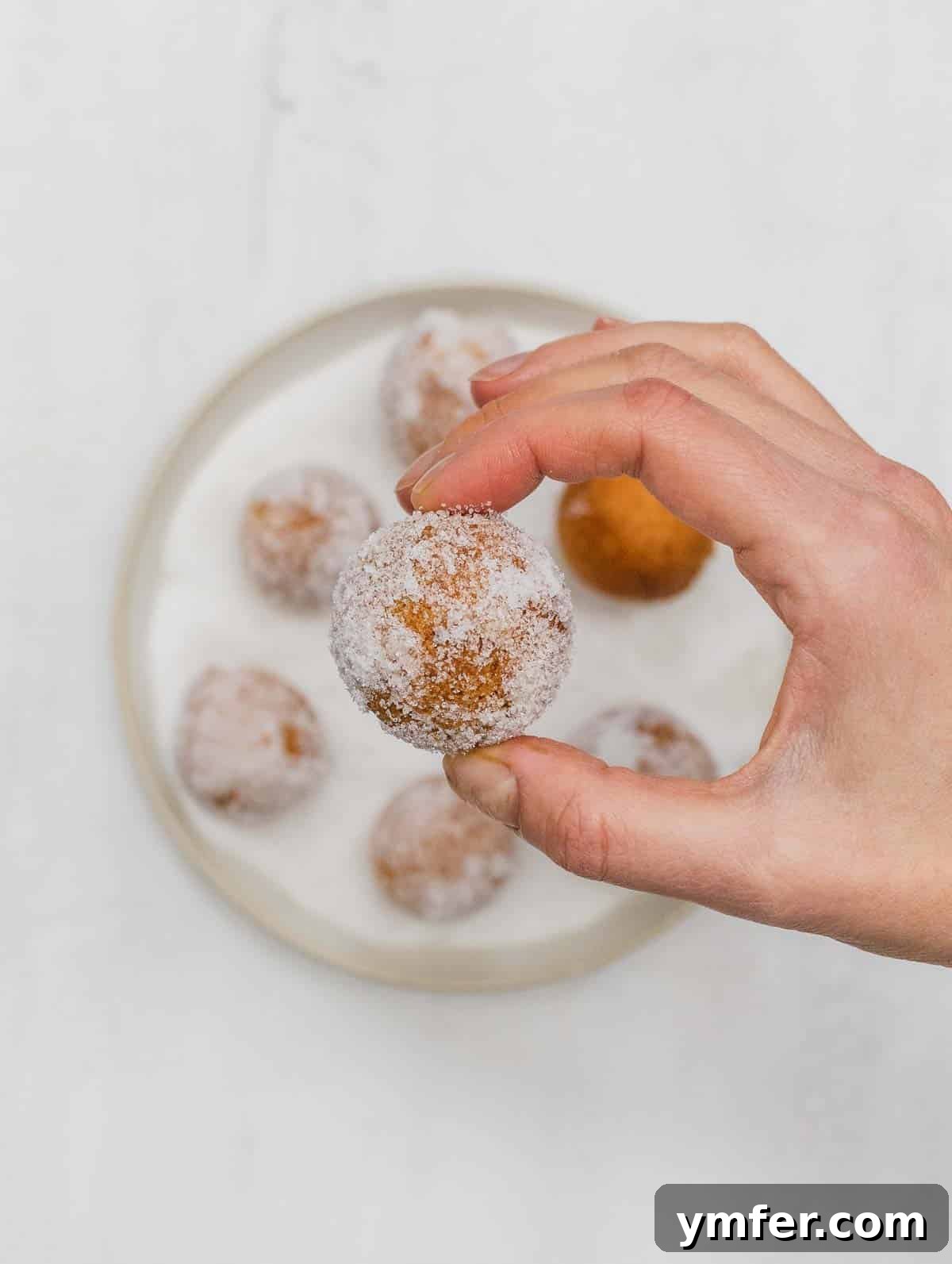 Castagnole Italian Carnival Fritters 20 Louise coating the deep-fried Castagnole in powdered sugar, creating a beautiful finish