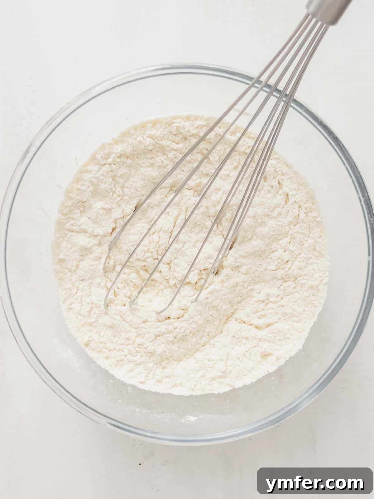 Castagnole Italian Carnival Fritters 7 Dry ingredients for Castagnole dough: flour, sugar, and baking powder, perfectly combined in a mixing bowl