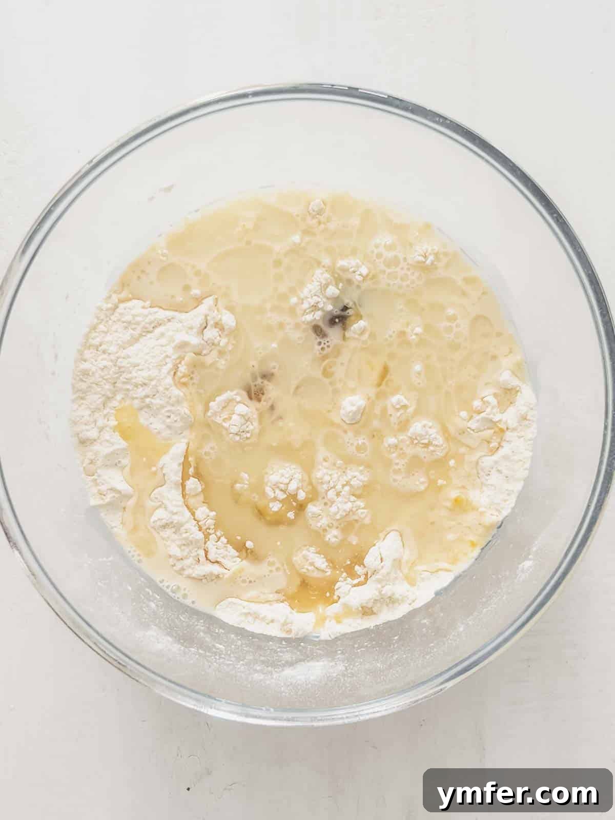 Castagnole Italian Carnival Fritters 8 Wet ingredients for Castagnole dough mixed with dry ingredients in a bowl, forming a vegan sweet dough