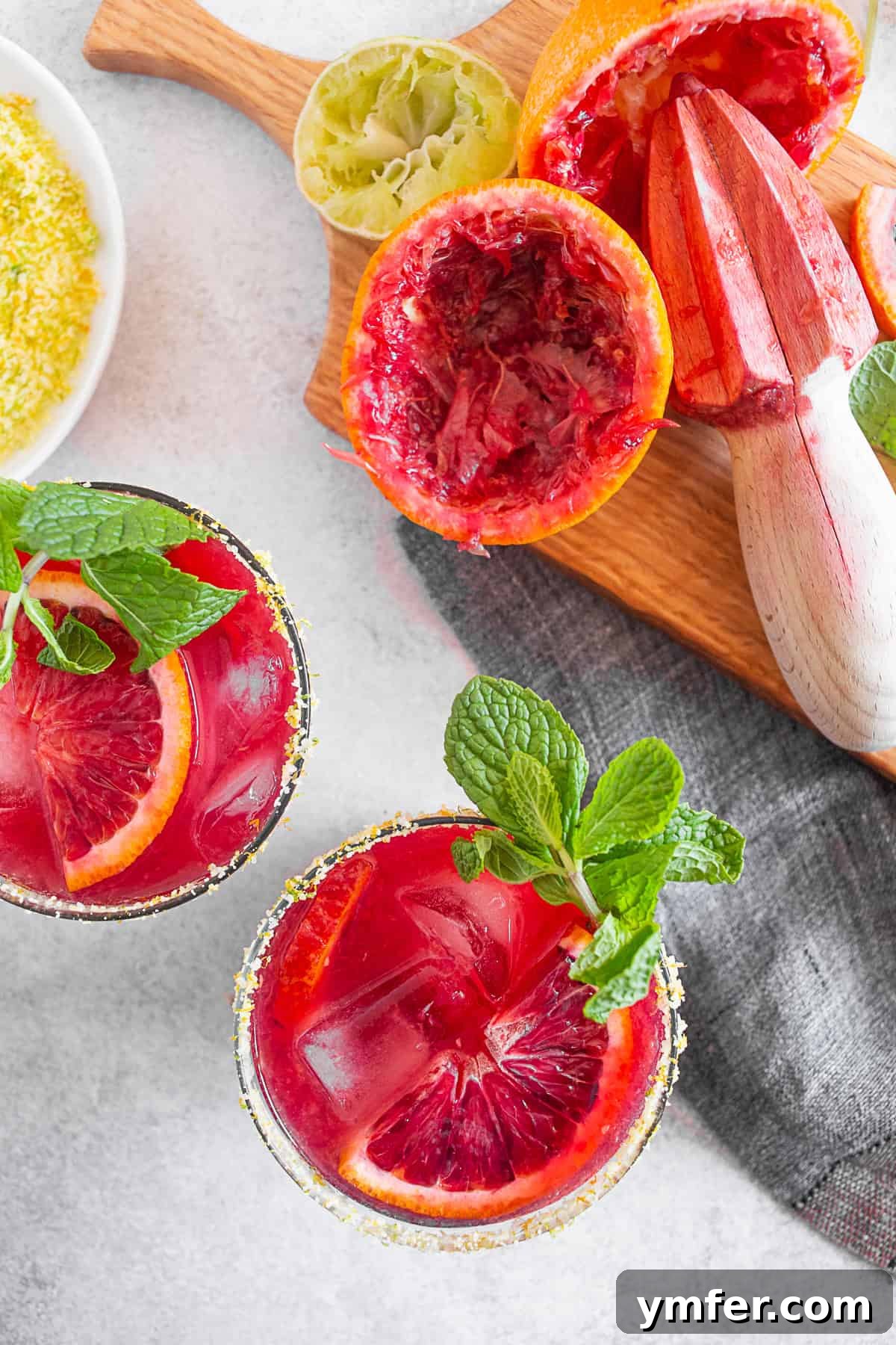 Ruby Red Margarita 5 Blood Orange Margarita garnished with a blood orange slice and mint sprig.