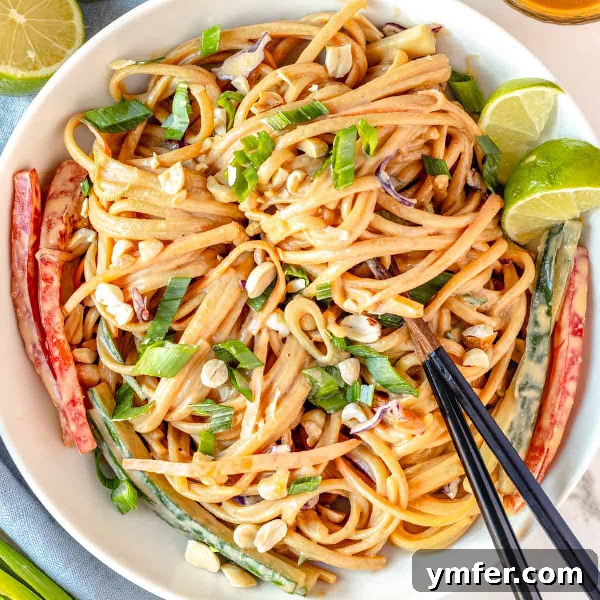 21 Fresh & Flavorful Summer Salads 20 Peanut noodles with chopsticks and vegetables, garnished with peanuts.