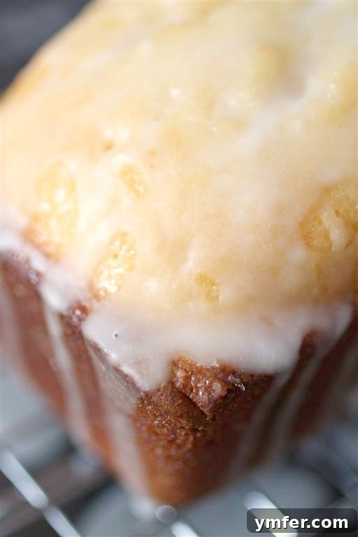 A delicious Lemon Loaf Cake, glazed with lemon syrup and drizzled with lemon glaze, perfect for lemon lovers.
