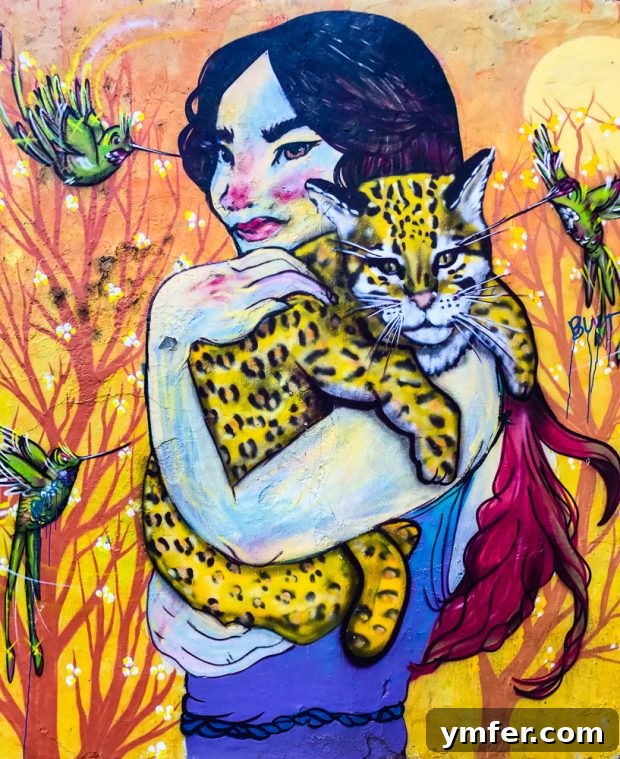 Valparaiso Street Art: Explore Chile's Open-Air Gallery 2 Colorful Valparaiso street art on a building facade, showing intricate patterns and bold hues, with a glimpse of the city's hilly landscape.