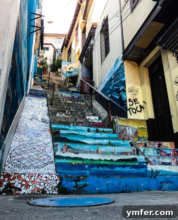 Valparaiso Street Art: Explore Chile's Open-Air Gallery 7 A beautifully painted staircase in Valparaiso, featuring vibrant colors and patterns that lead up a steep hill.