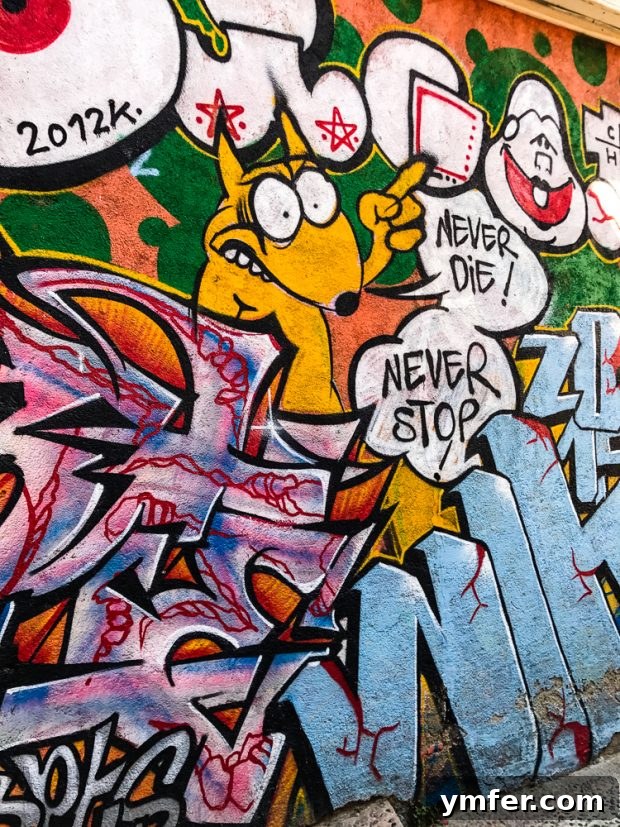 Valparaiso Street Art: Explore Chile's Open-Air Gallery 10 A vibrant Valparaiso mural featuring an abstract design with a central human-like figure, bursting with color and dynamic movement.