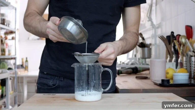 Soy milk, lemon and salt in a tall container