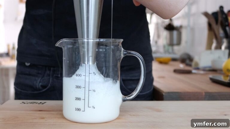 Blending the liquids while adding oil