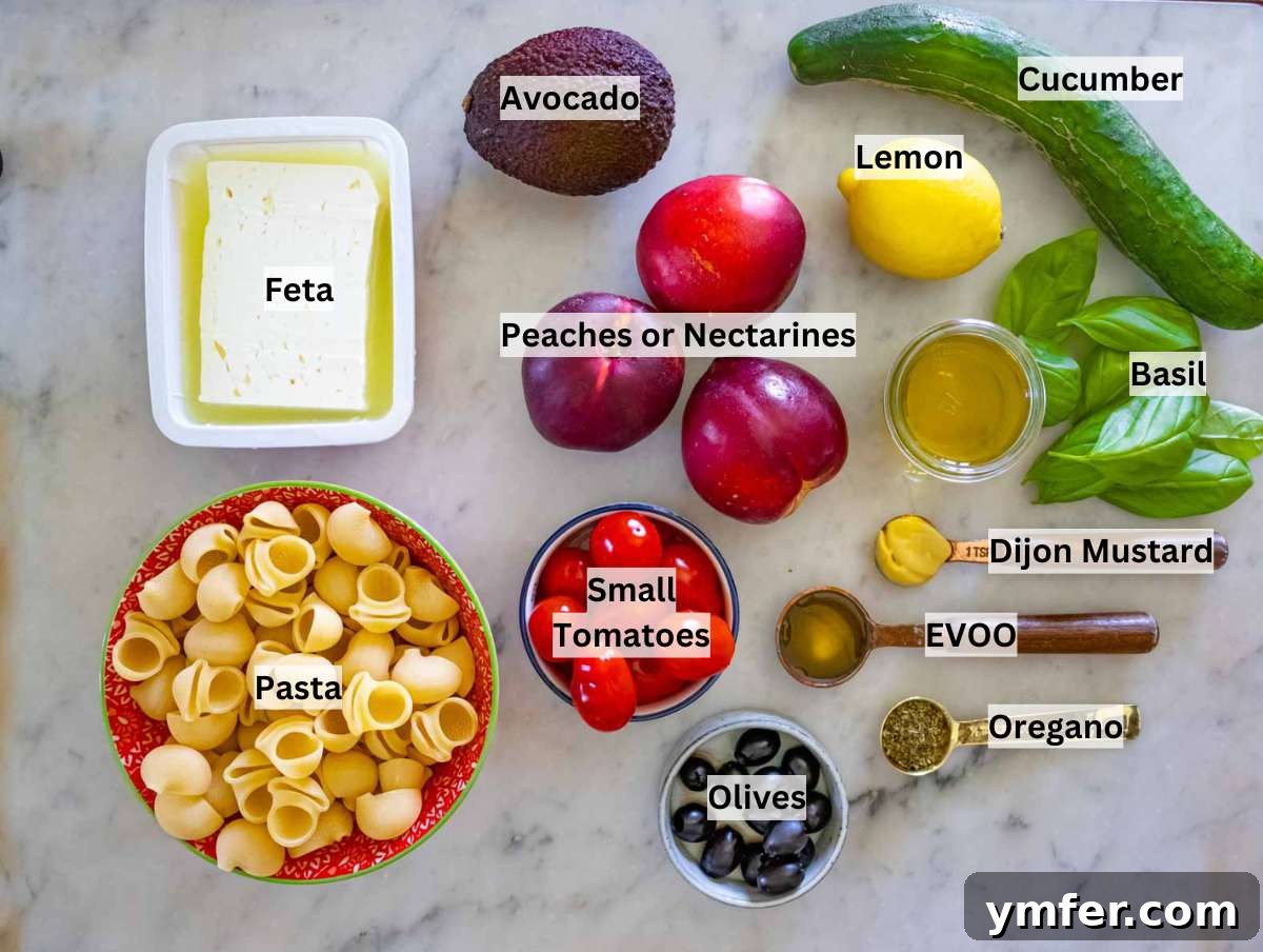 Summer Peach & Creamy Feta Delight 4 Ingredients laid out for summer pasta salad, including peaches, feta, avocado, pasta, cucumber, cherry tomatoes, olives, and lemon.