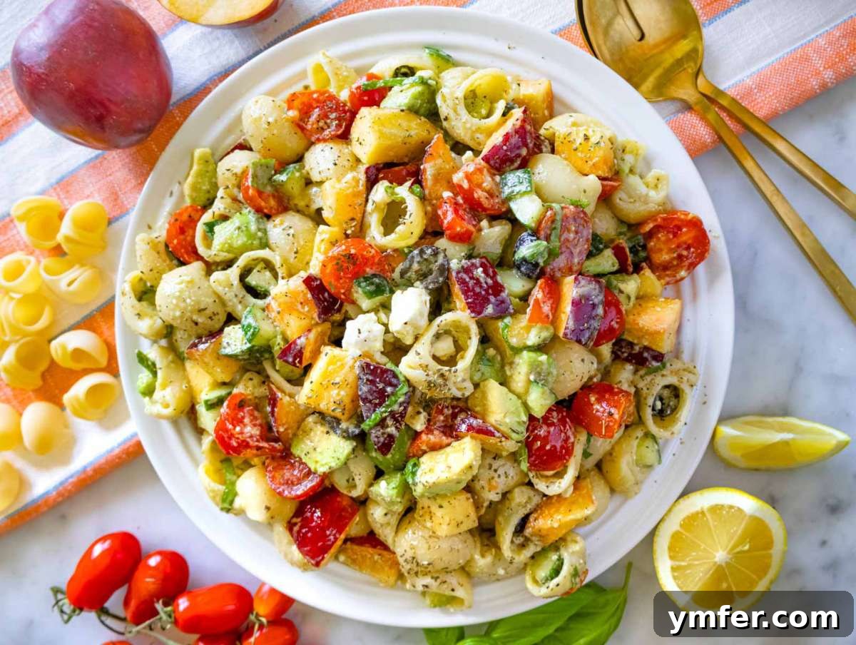 Summer Peach & Creamy Feta Delight 8 Fully mixed summer pasta salad on a platter, creamy and colorful, ready to enjoy.